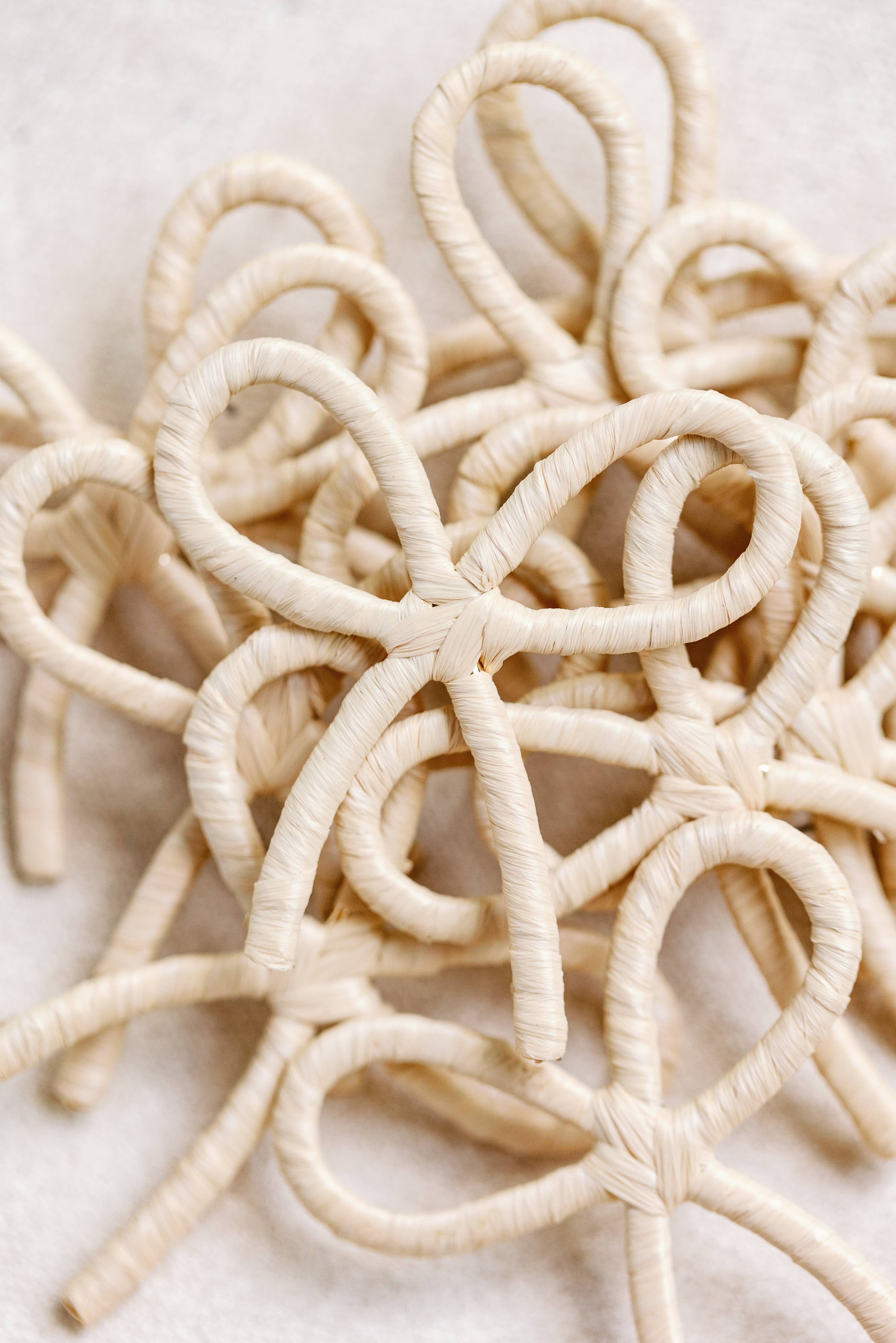 NATURAL RAFFIA WRAPPED BOW STATEMENT EARRINGS