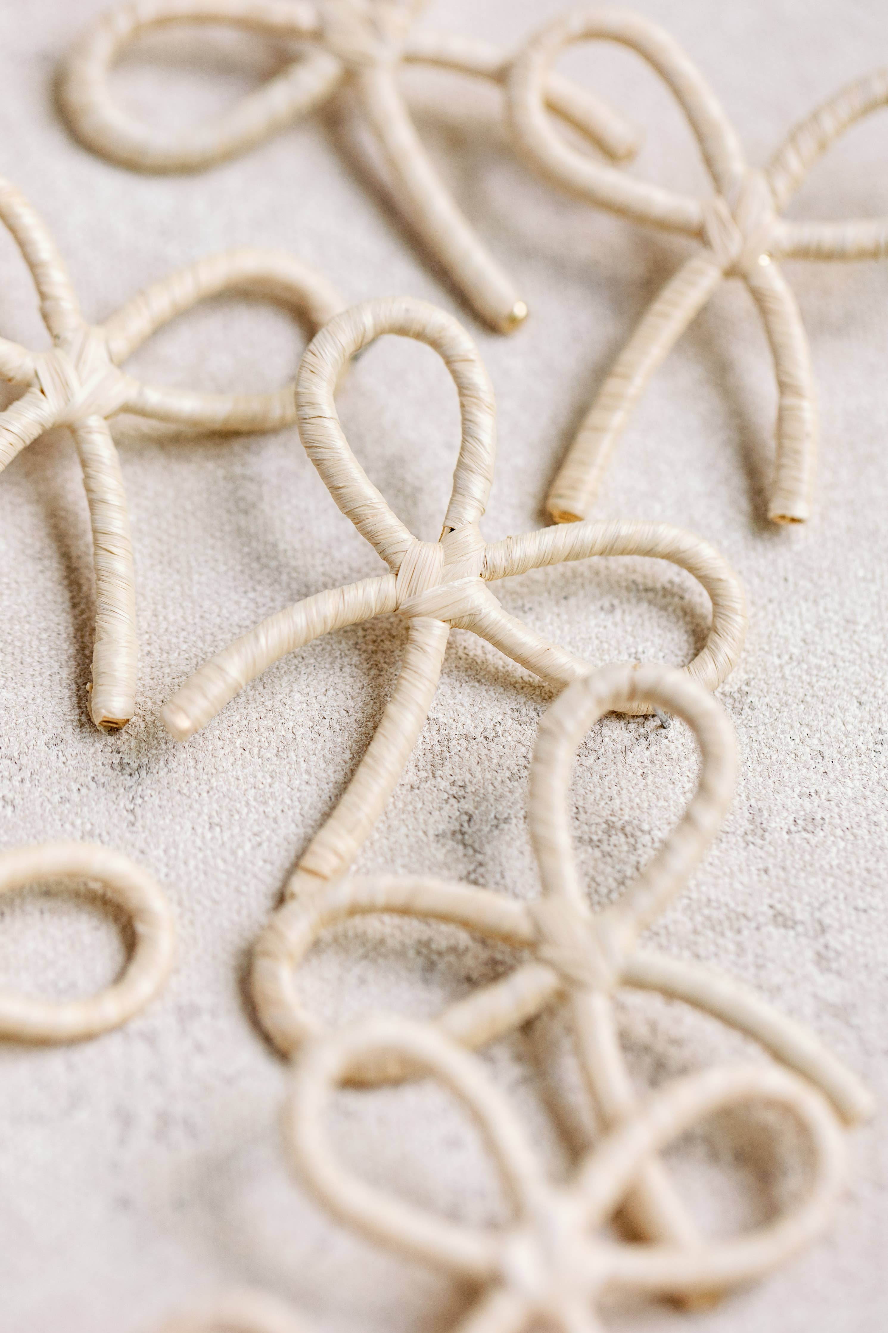 NATURAL RAFFIA WRAPPED BOW STATEMENT EARRINGS